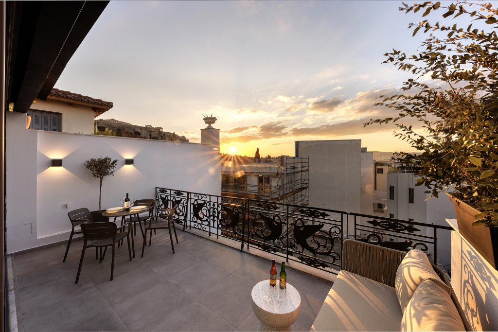 Private balcony at master Plaka Athens, offering stunning city views and a glimpse of historic Athens.