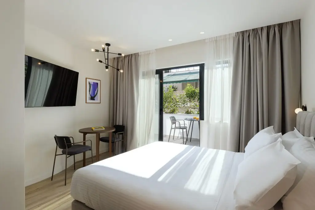 Relaxing bedroom area in the Studio with Balcony at master Plaka Athens, seamlessly connecting to a private outdoor retreat.