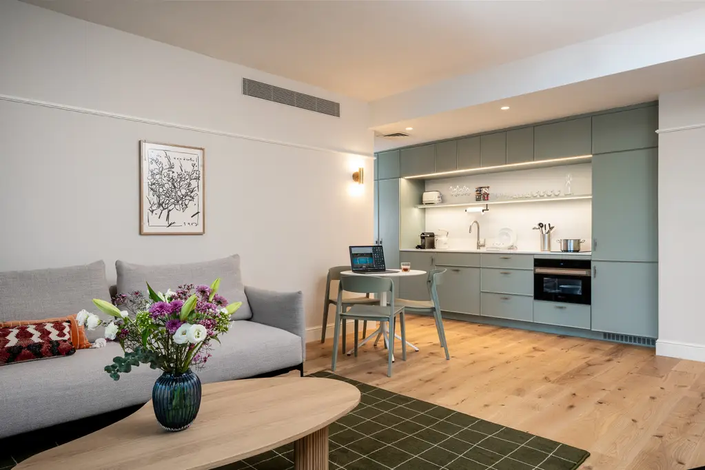 Well-designed kitchenette in the One-Bedroom with Sofa Bed at master Mazeh Tel Aviv, blending contemporary style with practical features.